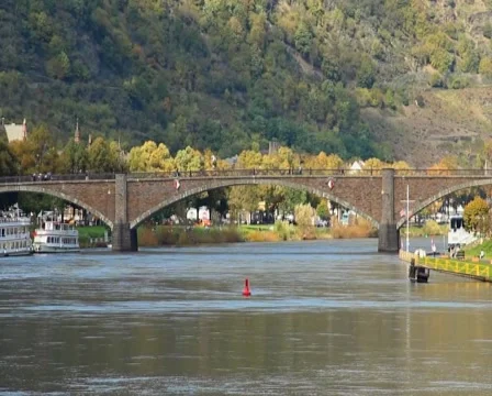 Brick bridge over river, car traffic, green hills people walking, click for HD Stock Footage 43911964