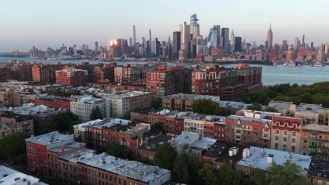 Brick brownstone rooftops fill Hoboken neighborhood, Manhattan skyline rises Stock Footage 340970357
