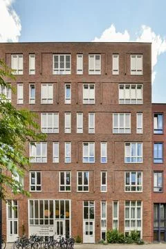 A brick building with bikes parked in front of it Stock Photos