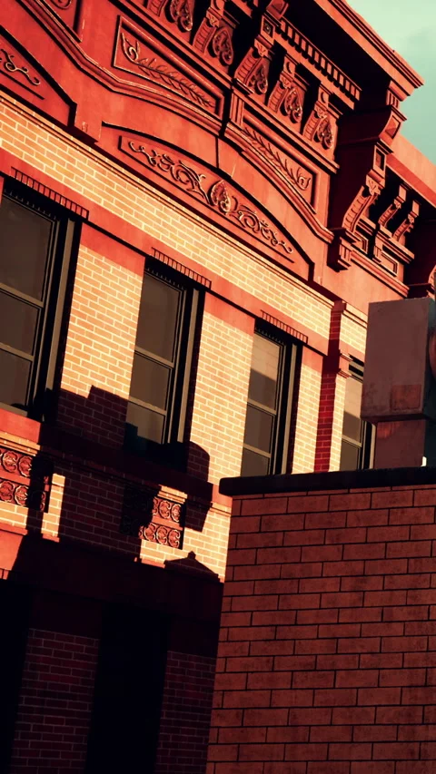 Brick building with detailed architecture and shadows in afternoon light Stock Footage 338352602