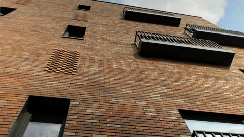 This brick building features geometric balconies and modern windows Stock Footage 341468622