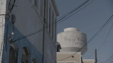 Brick Building in Foreground with Pan into Cleveland, Ohio Water Tower Stock Footage 89945200