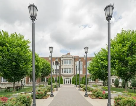 Brick building with lamp posts and garden path 스톡 사진