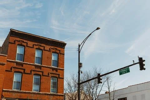 A brick building is seen at the corner of Lydig Avenue. The sky is blue with  Photos