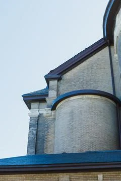 Brick building structure with curved elements and a clear sky at a historic.. Stock Photos