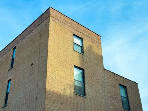 Brick building structure under blue sky with light clouds during daytime wi.. Stock Photos