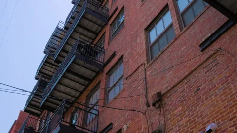 Brick building with sunlight streaming in behind it Stock Footage 279422949