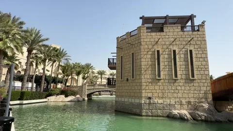 Brick Building with Tall Windows by a Water Canal and Wooden Bridge Stock Footage 303371100