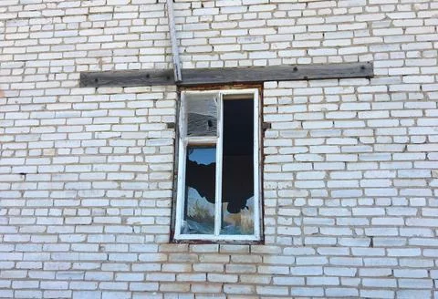 A brick building with a window Stock Photos