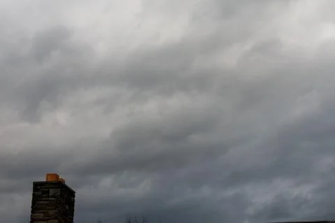 A Brick Chimney on a Cloudy Overcast Sky Stock Photos