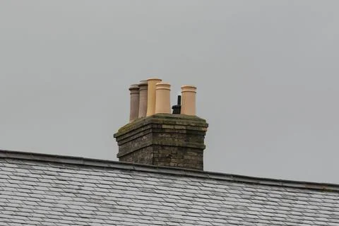 Brick chimney stack with different styles of pot Stock Photos