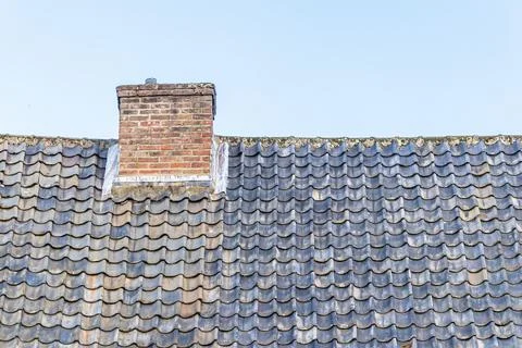 Brick chimney stack on the modern contemporary house rooftop Stock Photos