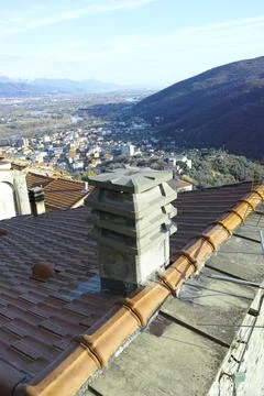 Brick chimney stack on modern contemporary house roof top. Stock Photos