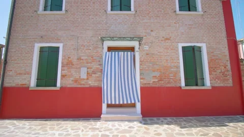 Brick-cladding house with curtain covering entrance door Video stock 163464725