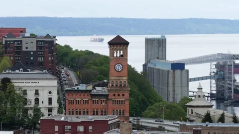 Brick clock tower rises above cityscape near historic Elks Temple building Stock Footage 337747602