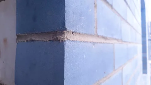 Brick construction. A brick wall made of dark blue bricks. Stock Footage 345598500