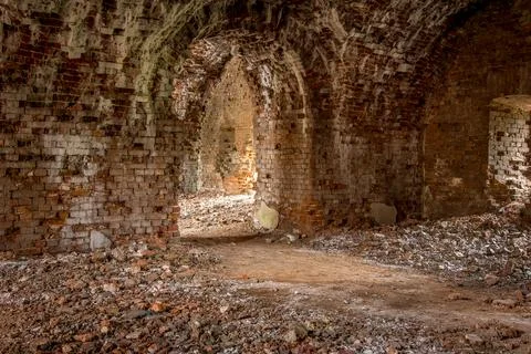 Brick corridor on the lower level in an old abandoned and decaying building Foto stock