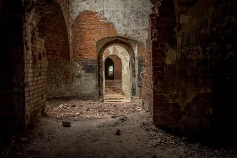 Brick corridor on the lower level in an old abandoned and decaying building Foto stock