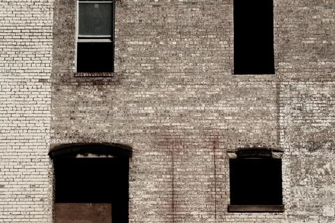 Brick facade and empty windows on old building Foto stock