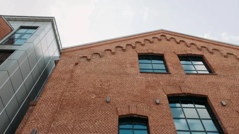 Brick facade of a building against a clear sky Video stock 282236932
