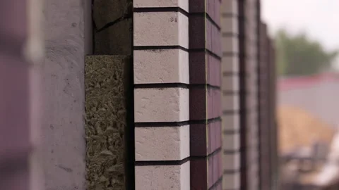 Brick facade with exposed insulation layer under construction close up Stock Footage 341985722