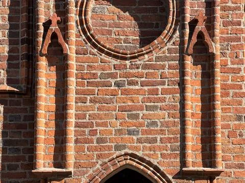 Brick facade with gothic circular and arched details Stock Photos