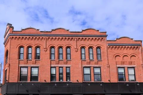 Brick facade of old fashioned 19th century commercial building Stock Photos