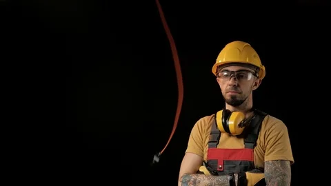 A brick falling from height towards a workers head which. Work safety concept Stock Footage 98980832