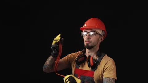 A brick falling from height towards a workers head which. Work safety concept Stock Footage 98981462