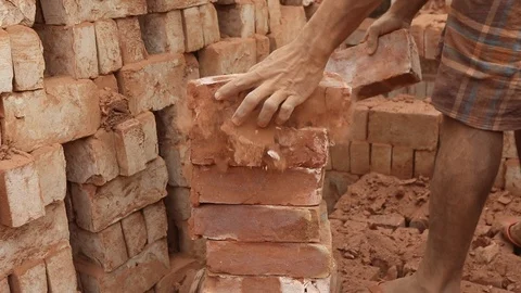 Brick field worker carrying complete finish brick Stock Footage 102579129