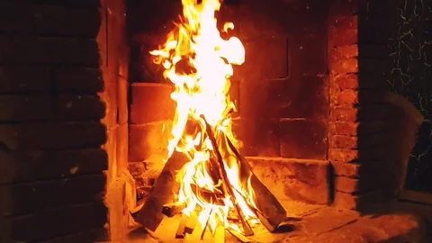 Brick fireplace with fire in winter time Stock Footage 127715999