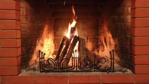 A brick fireplace in which a fire burns Stock Footage