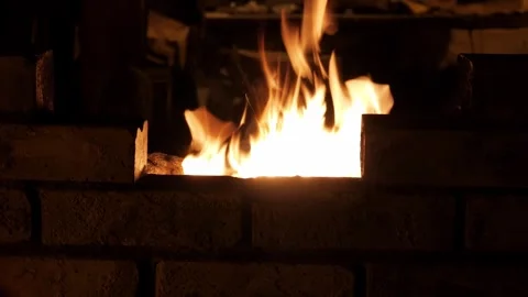 Brick Forge Flames Burning in Dimly Lit Workshop for Metalworking or Stock Footage 337691424