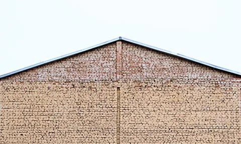 Brick house without windows. side view of roof top Stock Photos