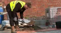 Brick layer mixing cement HD Footage