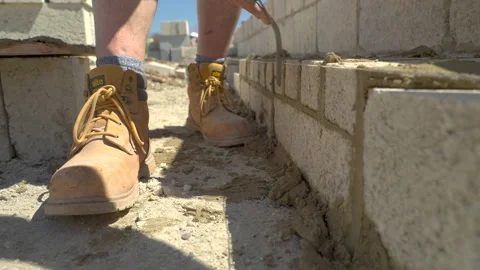 Brick Layer Points Up Wall Of Concrete Blocks 스톡 동영상 239678568