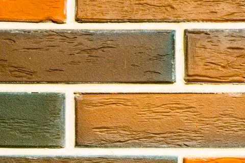 A brick level background. Texture or backdrop of decorative beige and brown Stock Photos