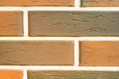 A brick level background. Texture or backdrop of decorative beige and brown Stock Photos