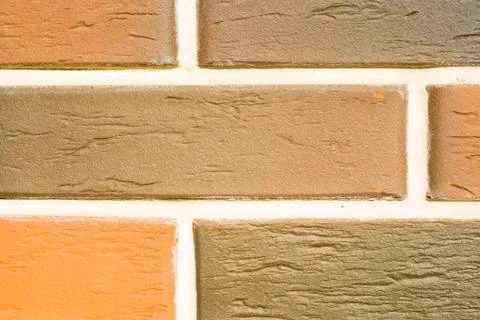 A brick level background. Texture or backdrop of decorative beige and brown Фото