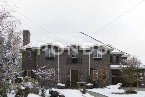 Brick Luxury Home in Snow Stock Photos