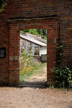 Brick opening frames the entry to the walled kitchen garden Stock Photos