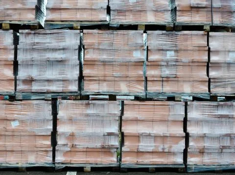 Brick packages packed in plastic foil outside  next to  the building material Stock Photos