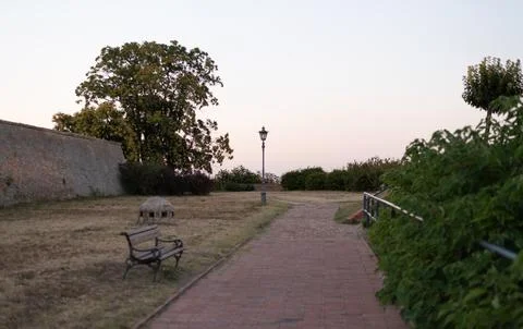 Brick pathway runs alongside the stone defensive walls of Petrovaradin Fortress Stock Photos