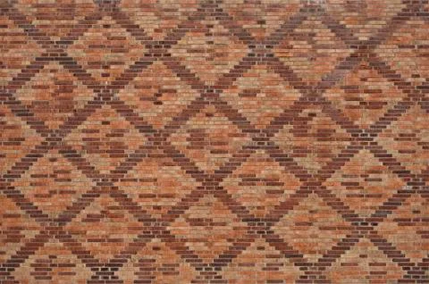 A brick pattern with a checkered pattern. Stock Photos