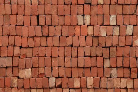 Brick Pattern. Stack of fresh processed bricks loosely stacked horizontally. Stock Photos