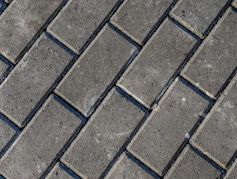 A brick patterned sidewalk with a black border Stock Photos