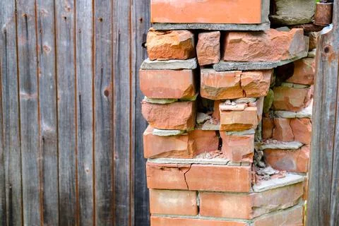 The brick pillar collapsed. Stock Photos