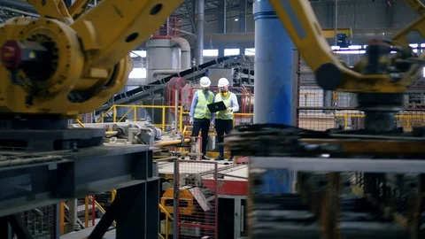 Brick-producing facility with two male workers standing in it Stock Footage 114309960