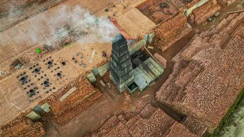 Brick production process taking place at a factory with stacked bricks and a Foto stock