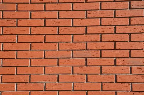 Brick red wall background. Building facade element. Stock Photos